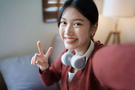 Portrait of beautiful Asian woman selfie with smiling face and showing signs of encouragement