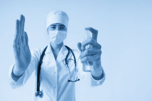 doctor applying antibacterial spray on hand on white background