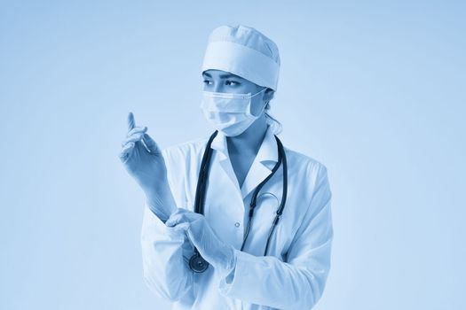 Young doctor putting on surgical gloves over white background