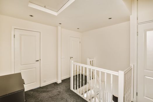 a white stairwell in a home with white doors