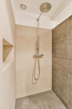 a shower with a shower head in a bathroom