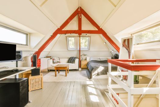 a lofted bedroom with a bed and a desk
