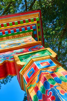 Colorful posts with Tibetan Mongolian Buddhist art at gate