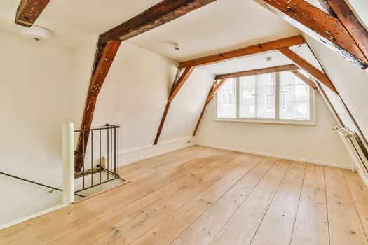 the living room with exposed beams and wooden floors