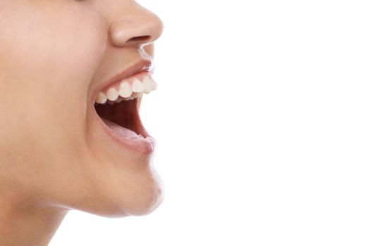 Laughing from her stomach. Closeup of a womans mouth laughing against a white background.