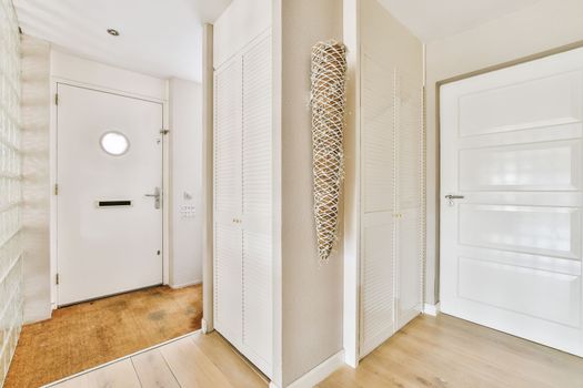 a hallway with white closet doors and a hallway mirror