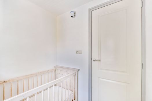 Light cozy baby room with cot