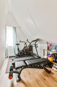 a home gym with exercise equipment in the attic