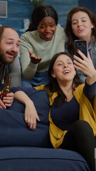 Multiracial friends speaking with collegue man during video call conference