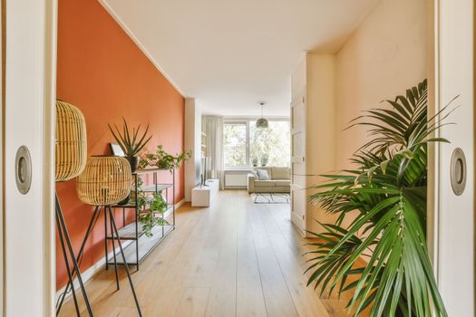 a living room with orange walls and a wooden floor