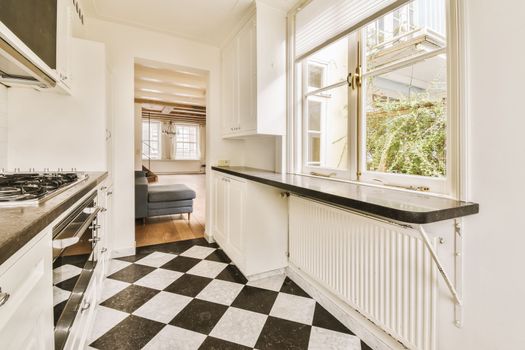 a kitchen with black and white checkered floor