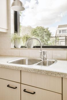 a kitchen counter with a sink and a window