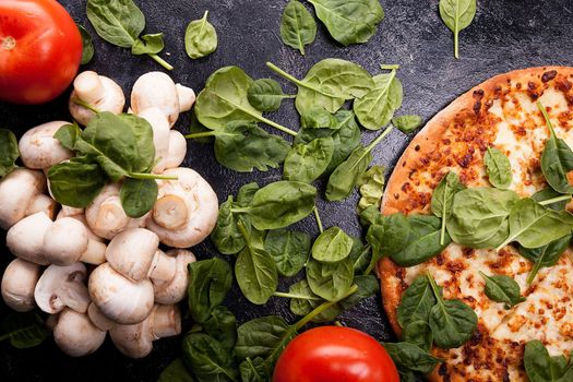 Mushrooms, spinach leaves, tomatoes and pizza