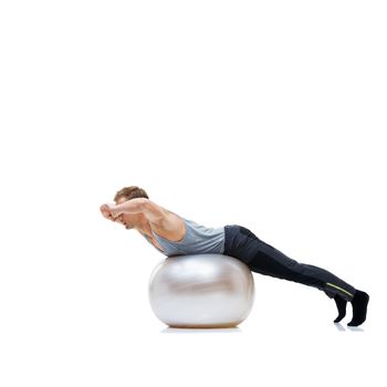 Balance is key. a man balancing on an exercise ball with a white background.