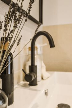a black faucet in a bathroom sink with
