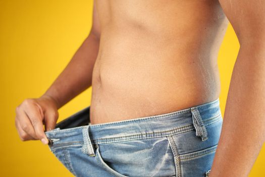 men put jeans and showing weight loss 