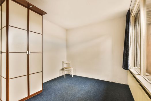 room with wardrobe and chair in the corner