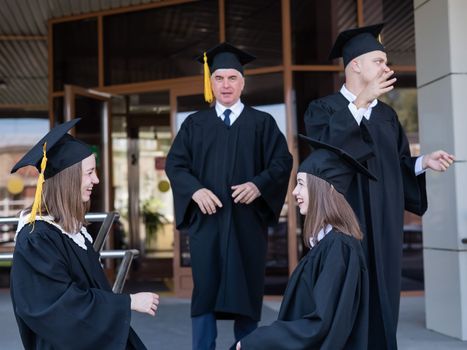 Classmates in graduation gowns. Accessible education for all ages