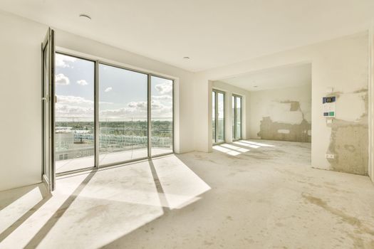 the living room of an empty house with glass doors