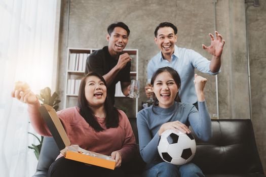 Excited friends having fun by watching football or soccer match and eating pizza at home. Friendship, leasure, rest, home party football, Soccer concept