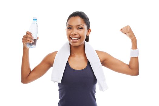 The results are obvious - Health Fitness. A young woman holding a bottle of water and flexing her biceps after an energizing workout.