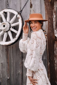 Beautiful girl in vintage lace dress and hat at the ranch