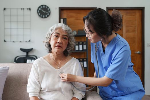 Asian youthful nurse caring for patients or the elderly at home. nursing at home concept