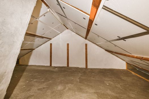 a large room with a concrete floor and exposed beams