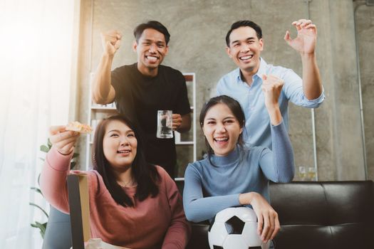 Excited friends having fun by watching football or soccer match and eating pizza at home. Friendship, leasure, rest, home party football, Soccer concept
