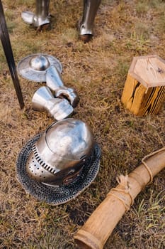 Knight's helmet, sword and battle horn on the ground