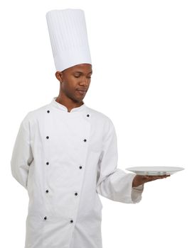 The food of your choice. An african chef holding a plate - Copyspace.