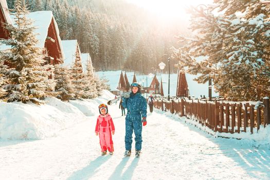 Image of sporty family spending time on winter resort during vacations