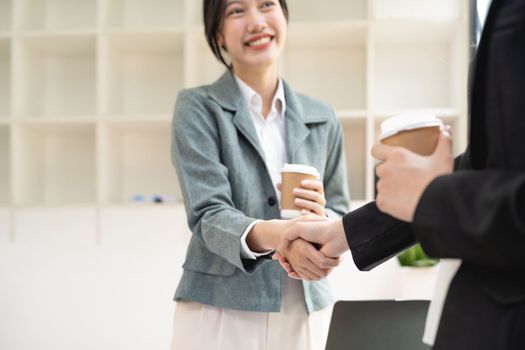 Handshake of businesspeople. Two asian female hand makes a handshake in the office