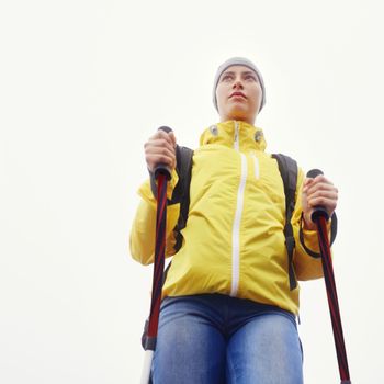 She hits the trail in any weather. Low-angle view of an attractive young woman standing in her hiking gear.