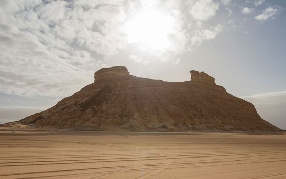 Barren desert landscape in hot climate with mountain
