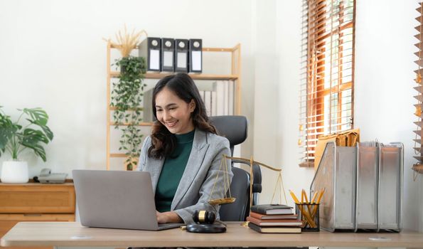 Asian business lawyer woman working with computer laptop in legal office.Law and Legal services concept.