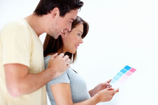 If its twins we can use both colours. An expecting couple looking over a blue and pink colour swatch for the babys room.