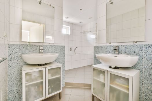 Sinks and bathtub near shower cabin