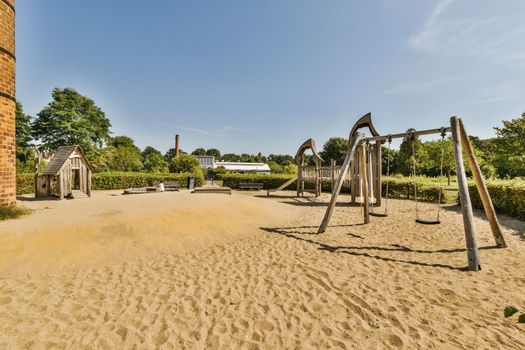 a playground with swings and sand in a park