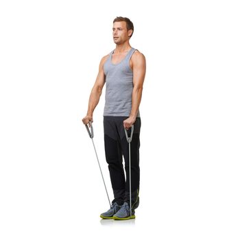 Resistance training. A fit young man working out with a resistance band while isolated on a white background.