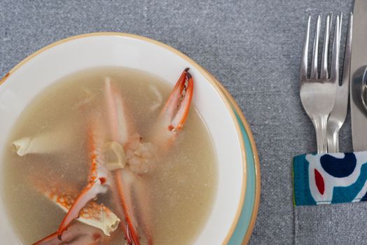 Crab soup a la carte meal in a bowl with cutlery