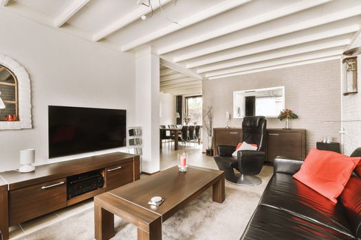 a living room with a leather couch and a television