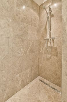 a bathroom with a shower and a tile floor