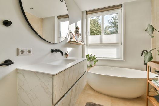 a bathroom with a white tub and a large mirror
