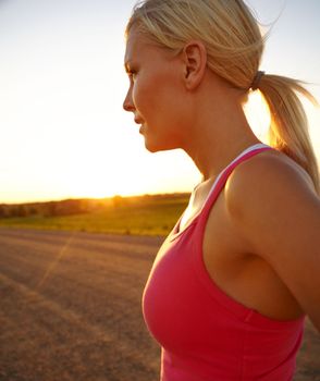 Dreaming of fitness. A beautiful young sportswoman looking at the sunset.