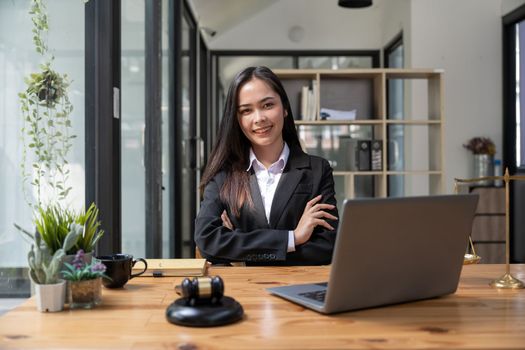 Asian business lawyer woman smiling at camera at workplace in an office