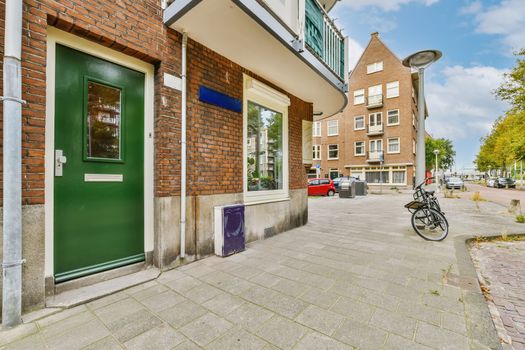 a building with a green door and a bike parked