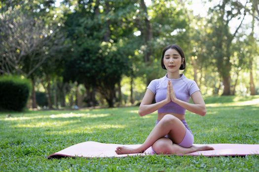 Portrait of happiness young woman practicing yoga on outdoors.Yoga and relax concept. Beautiful girl practice asana.