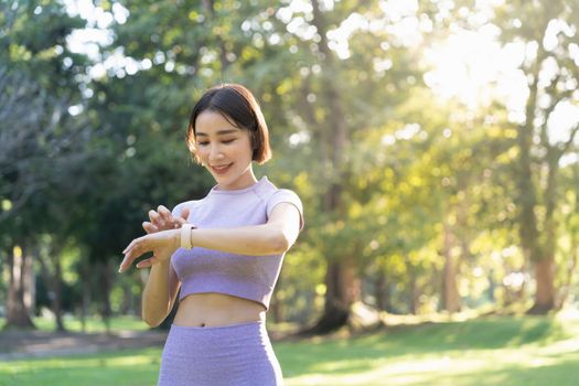 Young active sport woman using a smart watch to monitor her training progress after workout