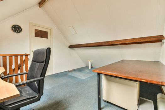 a small room with a desk and a chair